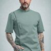 Olive Green Chef Coat with Concealed Button Design by SP Uniform – a modern professional chef uniform for hotels, restaurants, cafés, cloud kitchens and catering teams.